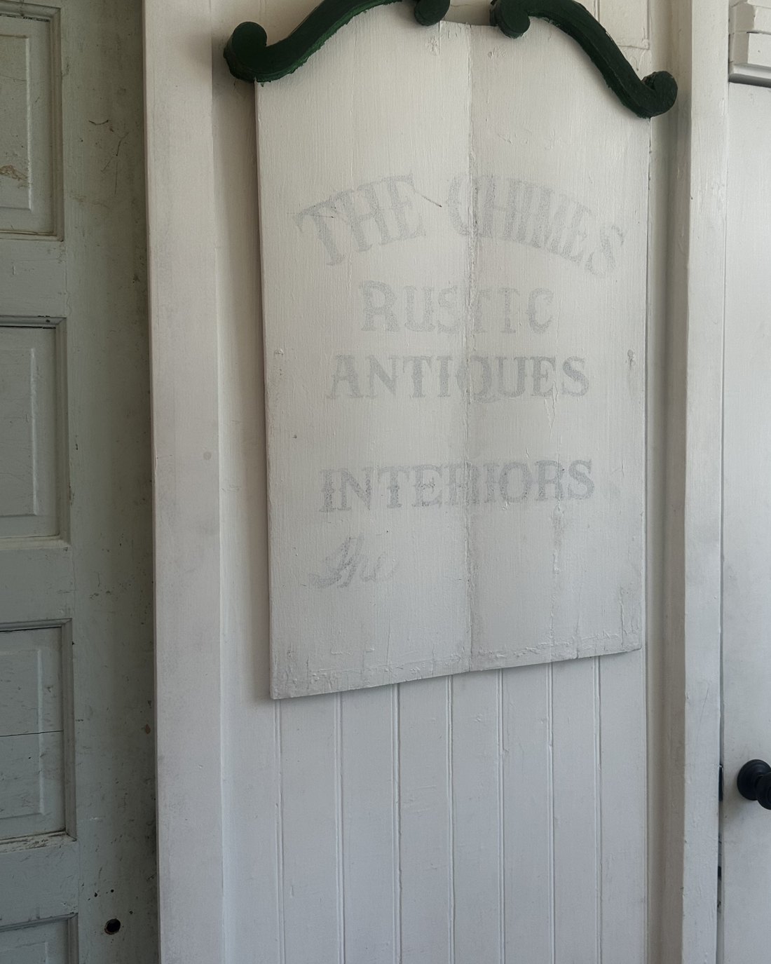 A weathered painted sign reading The Chimes, kept from the building's earlier years